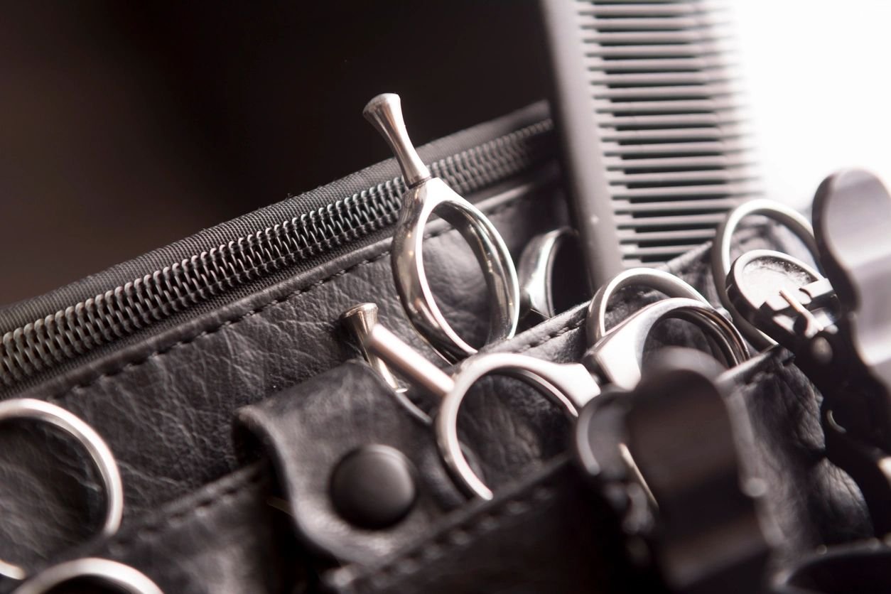 Stylist shears resting in a leather tool holster